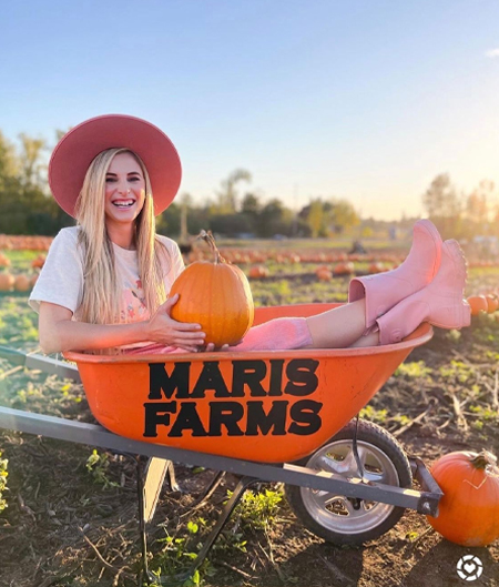 Woman In Maris Farms Wheelbarrow