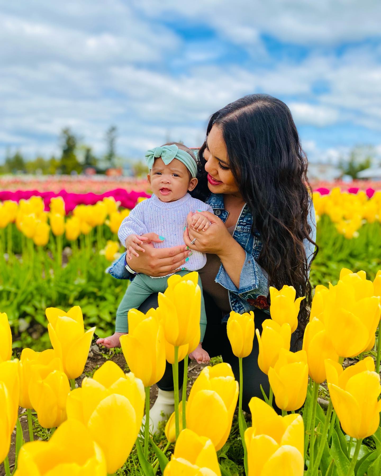 Family walking through tulip fields at Maris Farms Baby Animals and Blooms Days in Buckley WA